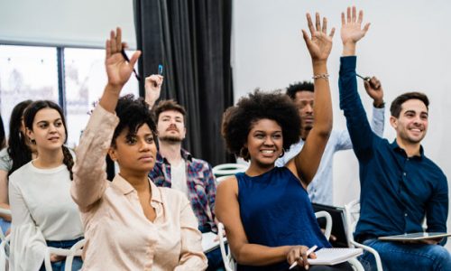 group-of-young-people-sitting-on-conference-together